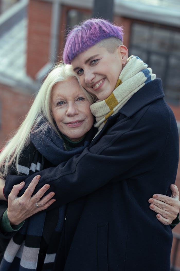 A Woman Hugging an Eldelry Woman